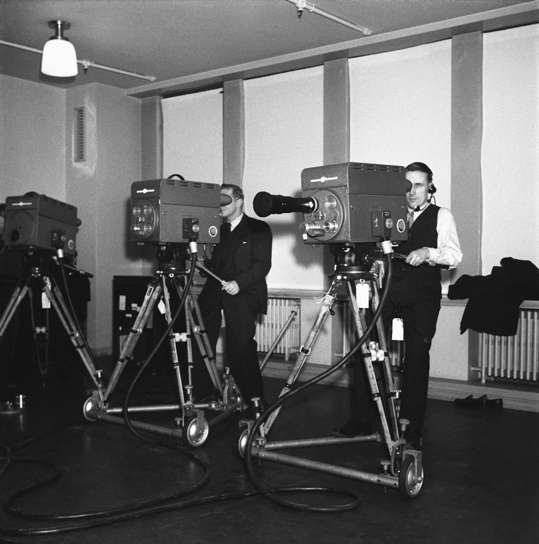 European man operating a television broadcast camera